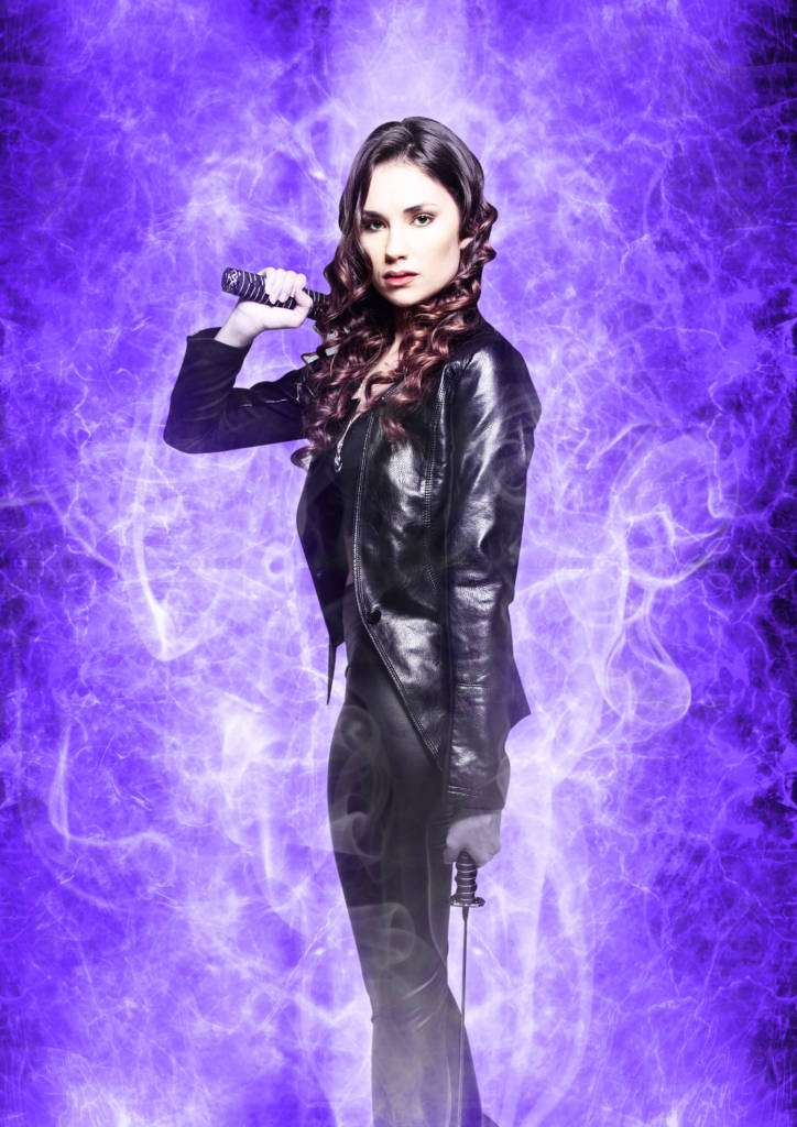 sexy brunette vampire with sword on purple background